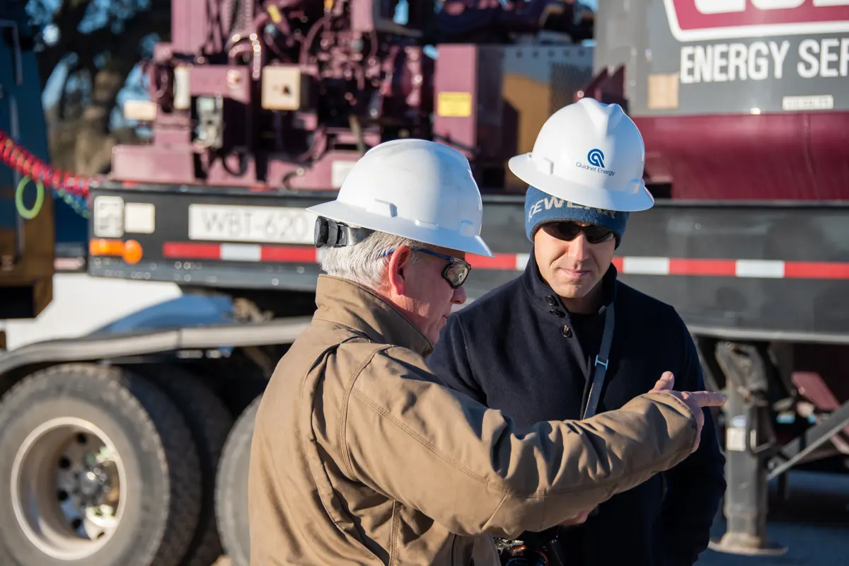 Quidnet employees Two people in hard hats onsite at a Quidnet site